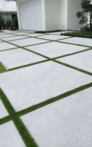 driveway exposed aggregate & sandblasted concrete with grass strips integral color stone gray
