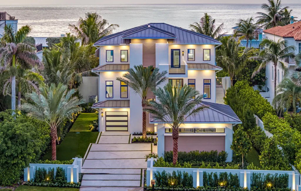 Modern home with custom designed driveway and pool deck using shell broadcast concrete in natural color