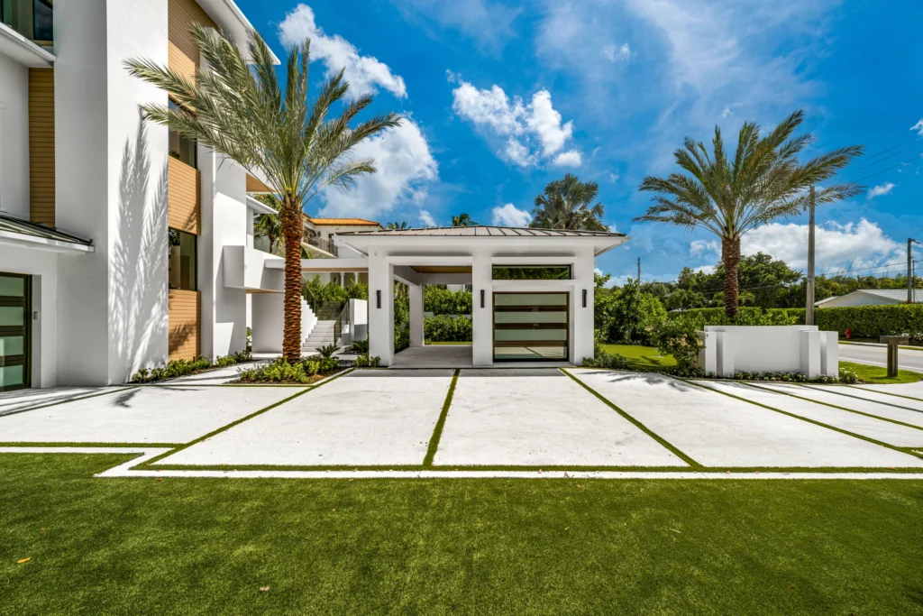 Modern residence showcasing a natural color shell broadcast concrete driveway designed in collaboration with Cobra