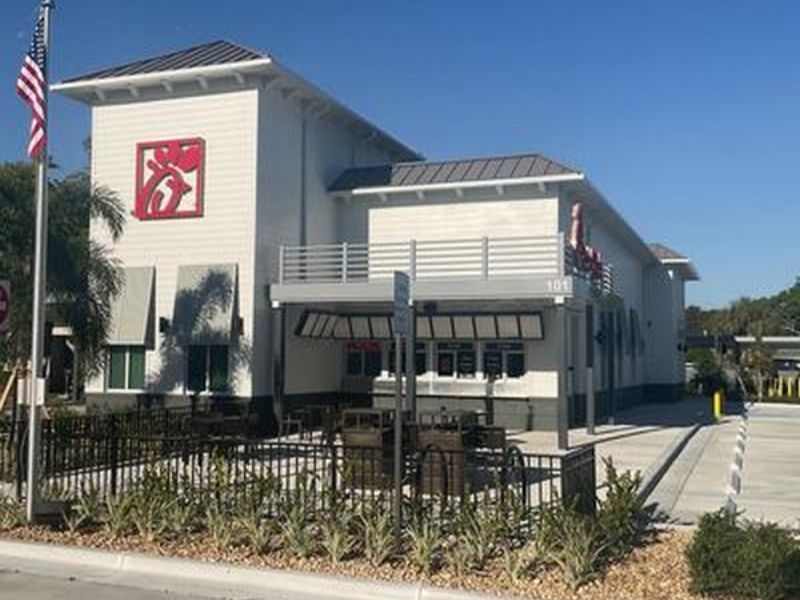 Restaurant exterior featuring concrete sidewalks, curbing, and landscaped edges at a Chick‑fil‑A location.