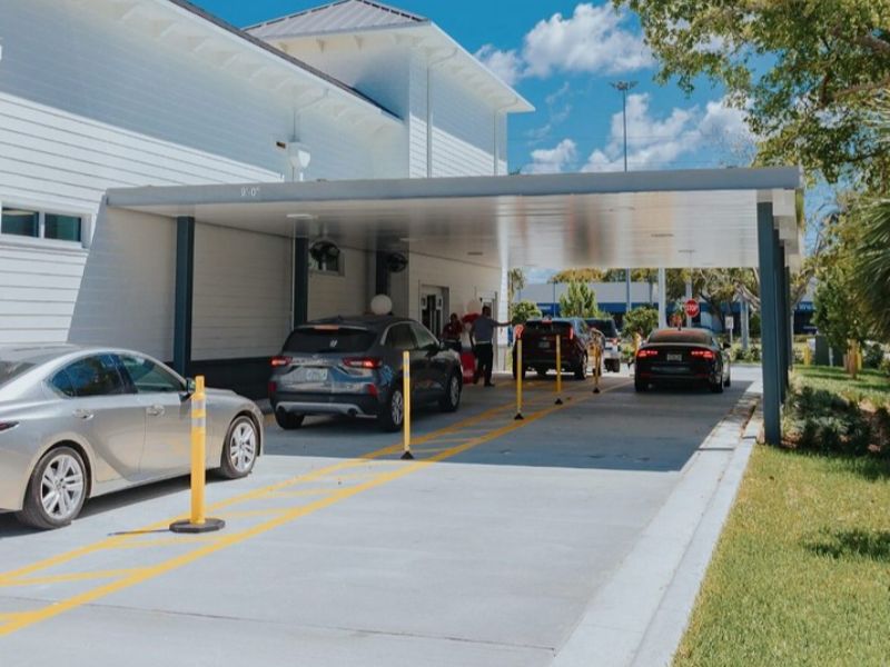 Commercial site showing concrete pavement with marked lanes and curbing at a drive‑thru facility